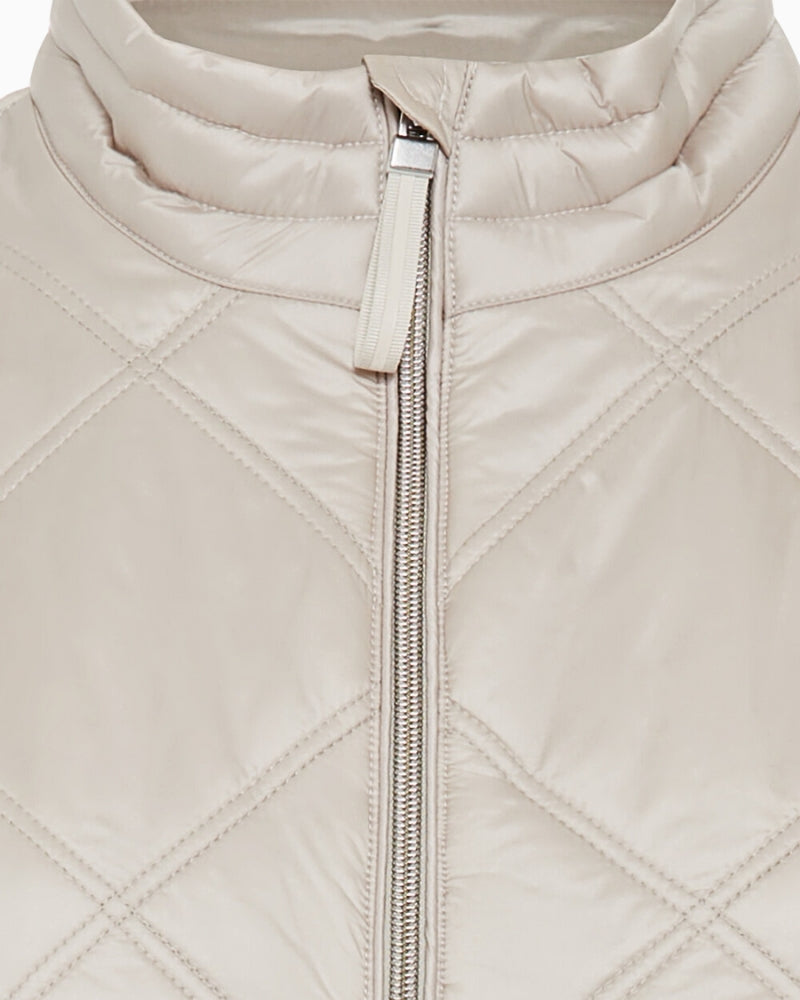 Close-up of quilted fabric and collar detail