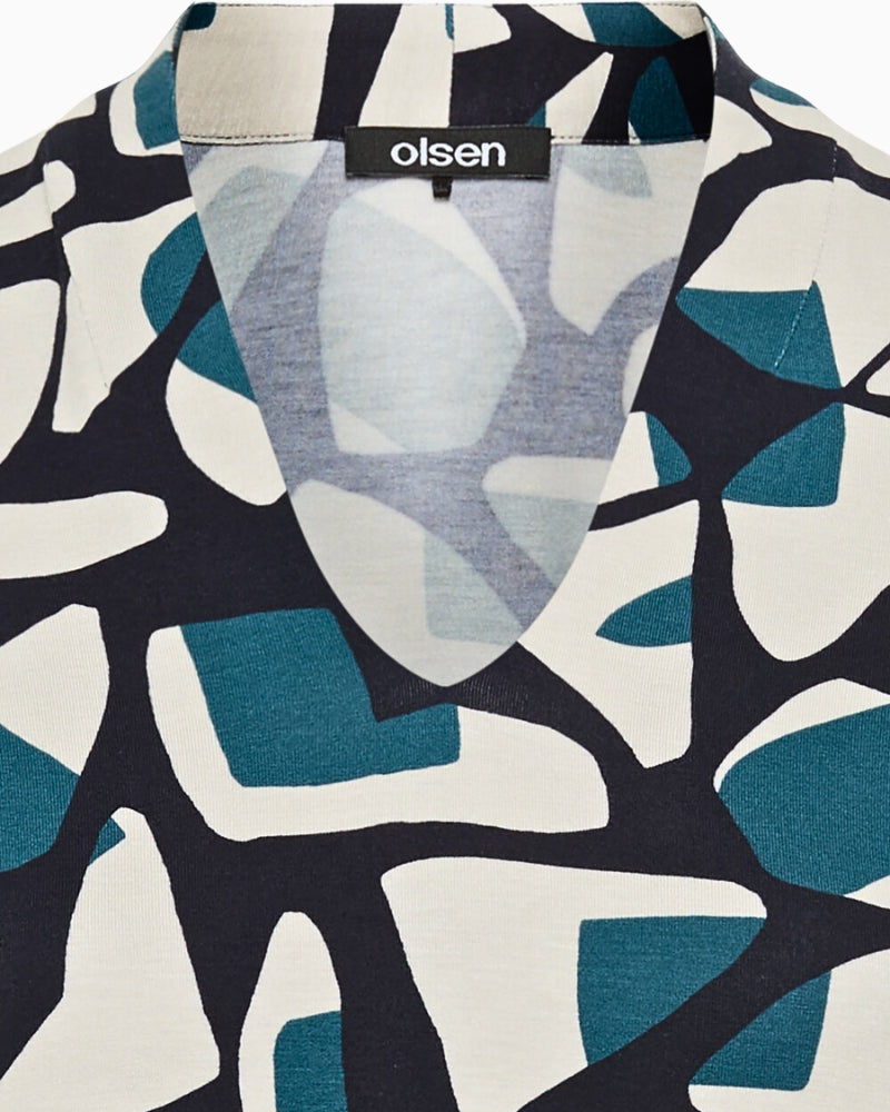 Close-up of geometric print on navy viscose blend top