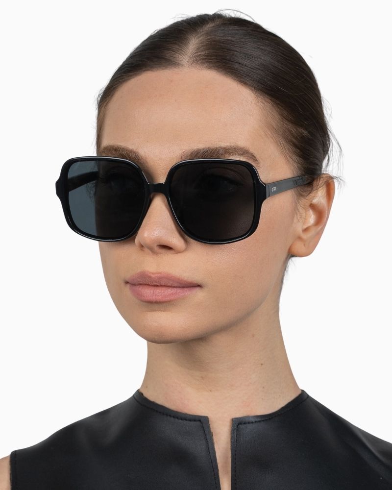 Side view of Otra Annie sunglasses showing glossy black finish and retro shape