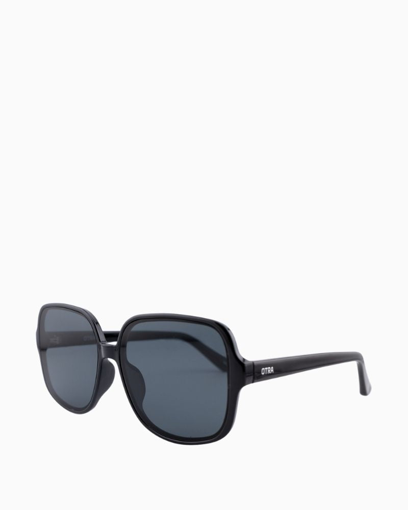 Side view of Otra Annie sunglasses showing glossy black finish and retro shape
