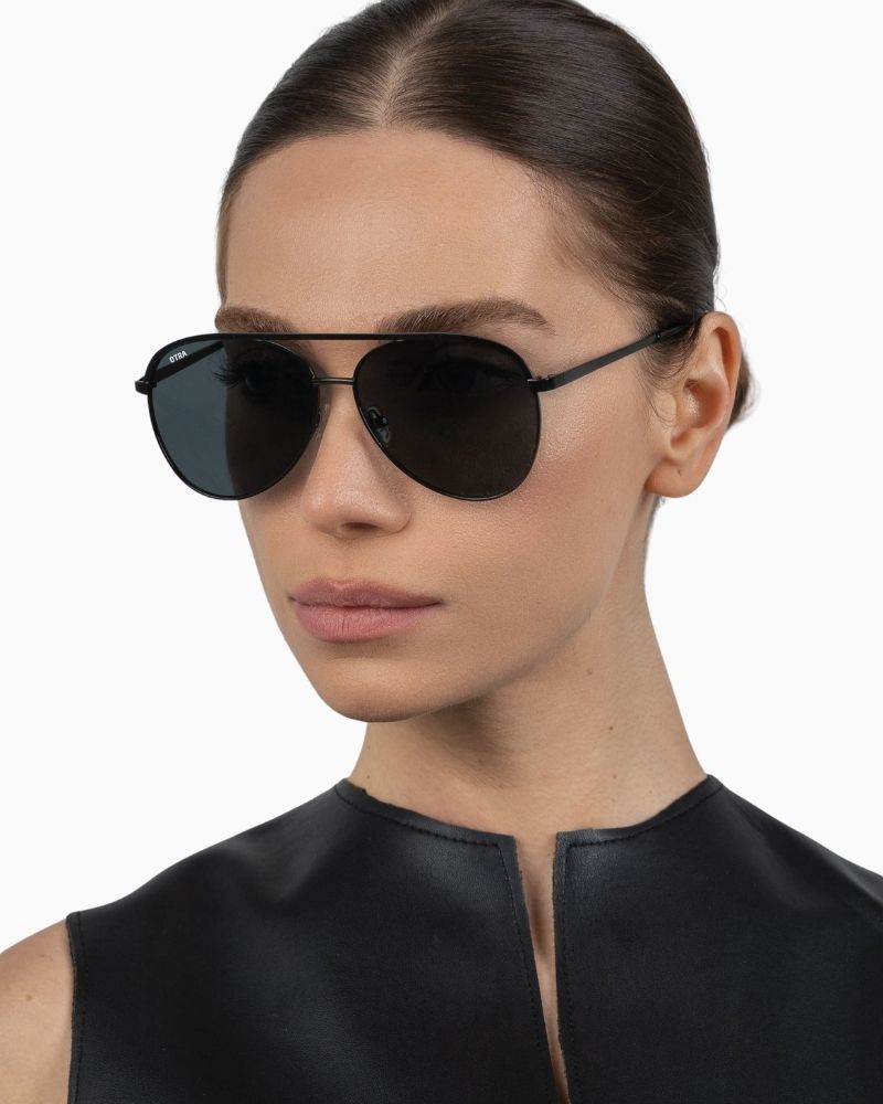 Close-up of Otra aviator sunglasses in black with Category 3 lenses and vegan pouch
