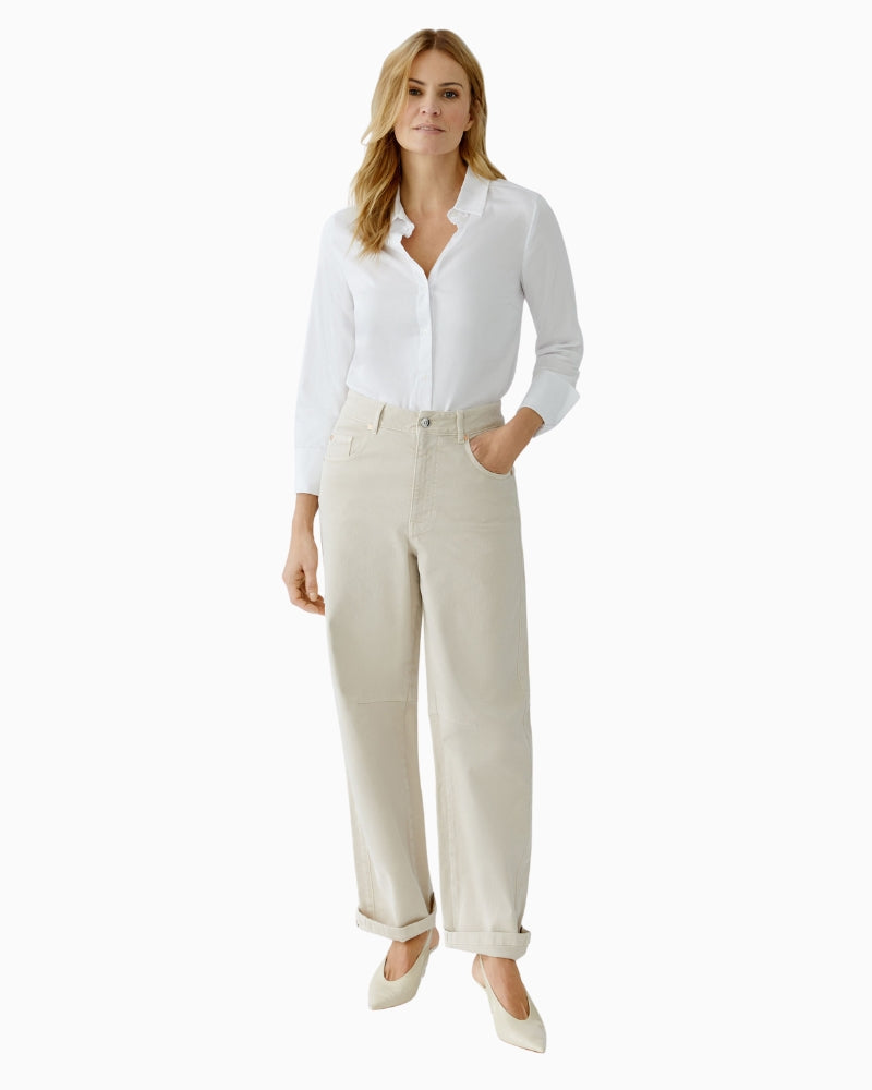 Model wearing off-white jeans with casual top