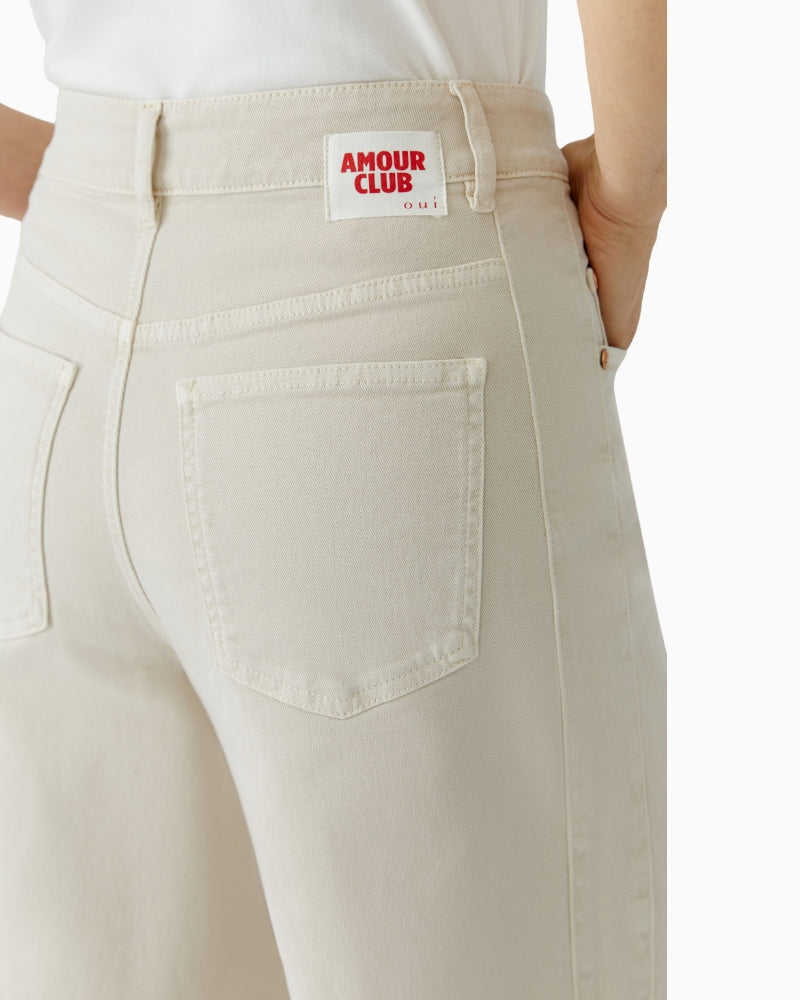 Flat lay of Oui barrel jeans showing curved leg and soft denim fabric