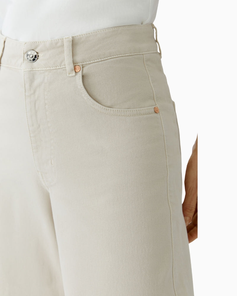 Close-up of zip and button closure on Oui cotton denim