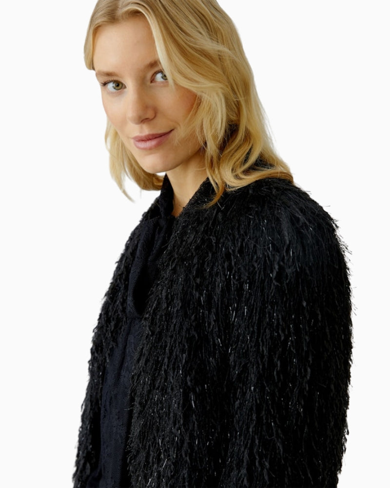 Close-up of fringe and lustre detailing on Oui black occasion jacket