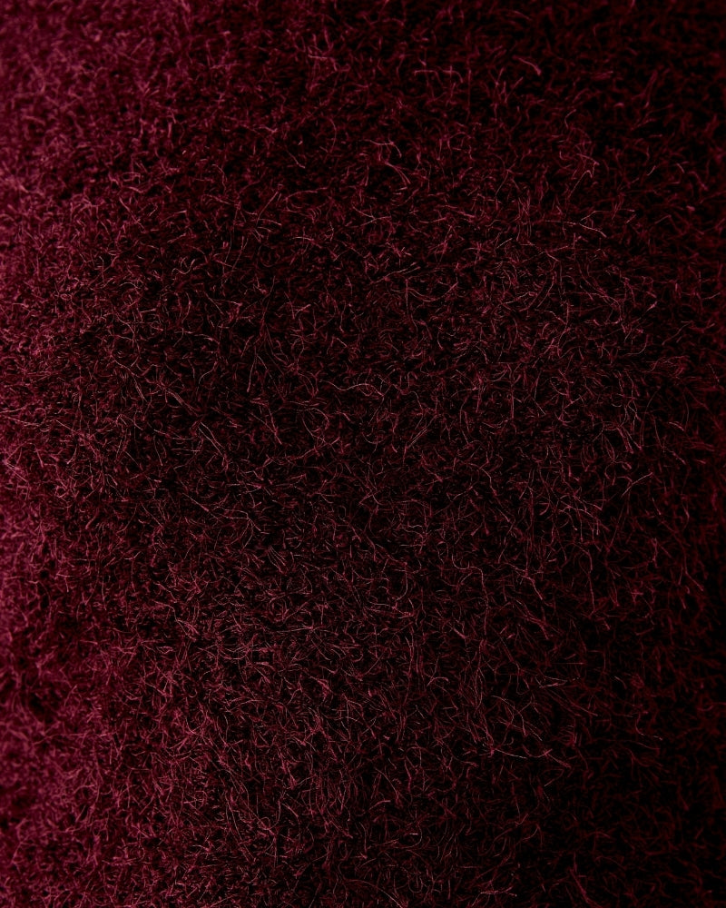Close-up of round neckline and ribbed hem detail