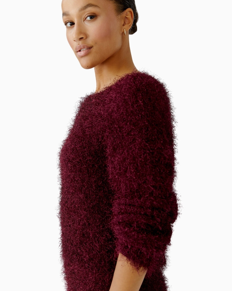 Close-up of round neckline and ribbed hem detail