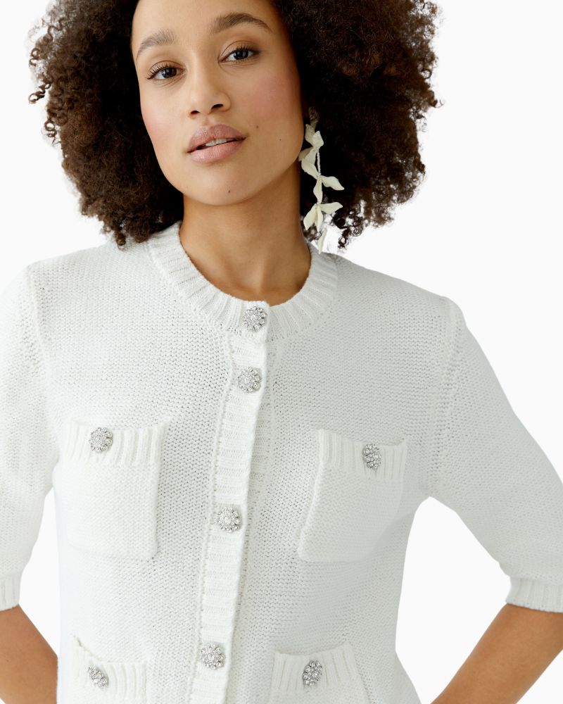 Close-up of Cloud Dancer cardigan showing decorative buttons and ribbed trim