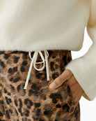 Close-up of knitted drawstring cord and overlock seam detail on Oui pullover