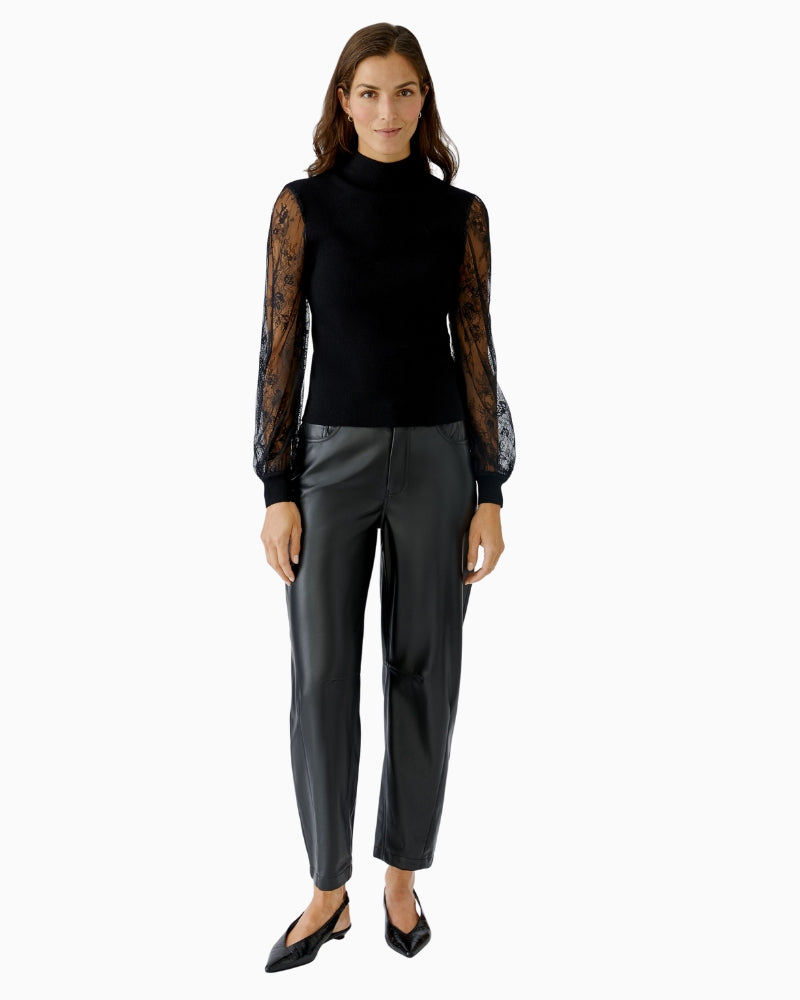 Model wearing Oui lace pullover with black trousers