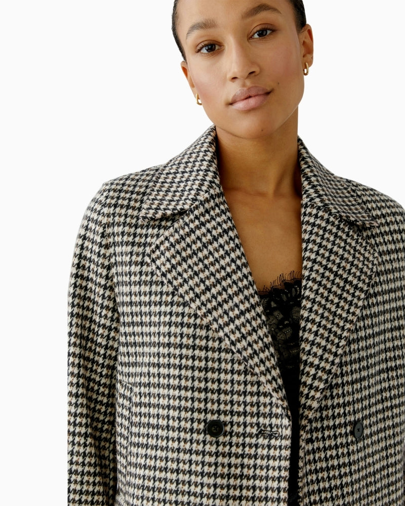 Close-up of lapel collar and textured cotton-blend fabric with a hint of lustre in light stone tone
