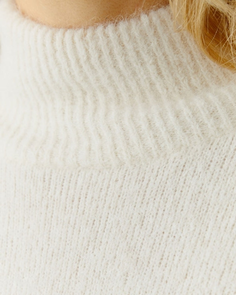 Close-up of ribbed stand-up collar and soft knit texture