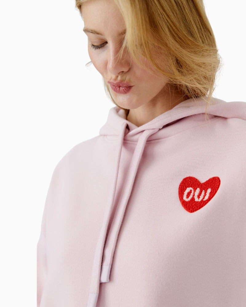 Close-up of heart logo detail on Oui hoodie in soft mauve shade