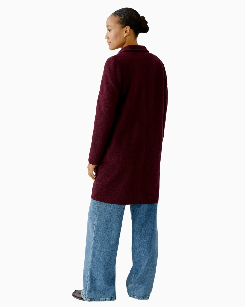Back of unlined wool coat by Oui showing clean lines and mid-thigh length