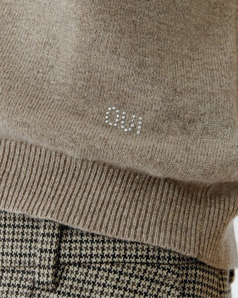 Close-up of neckline with delicate stone detail on taupe Oui sweater