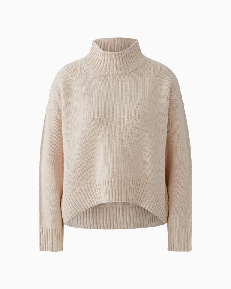 Front view of relaxed pink jumper with dropped shoulders and wide cuffs