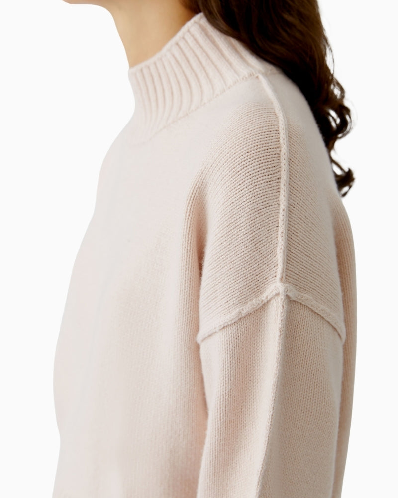 Side view showing longer back hem and rounded silhouette