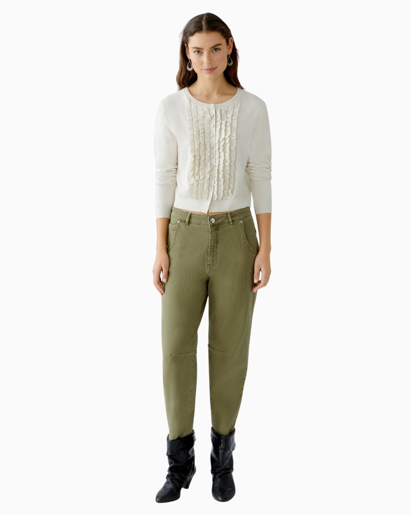 Detail of ruffle edge and round neckline in soft beige finish