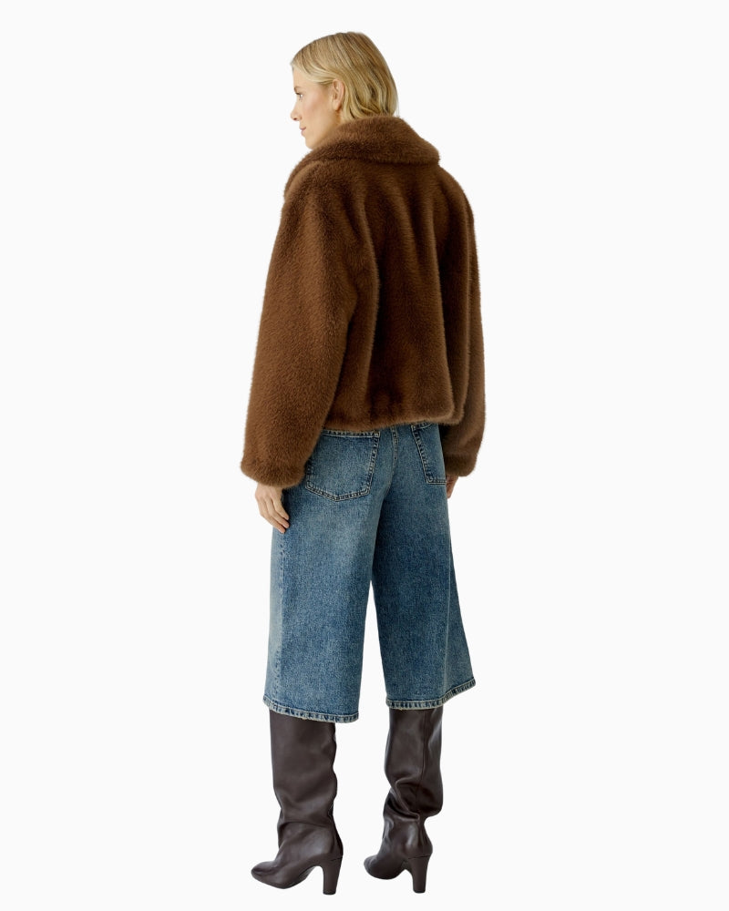 Back view of taupe faux fur jacket showing straight fit and soft faux fur texture