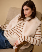 Side angle of Oui faux fur waistcoat styled casually with jeans