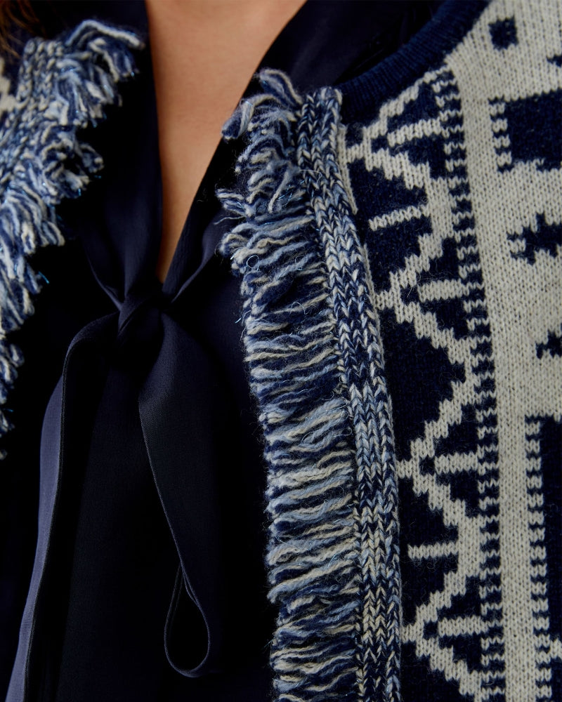 Close-up of fringe detail with subtle metallic thread