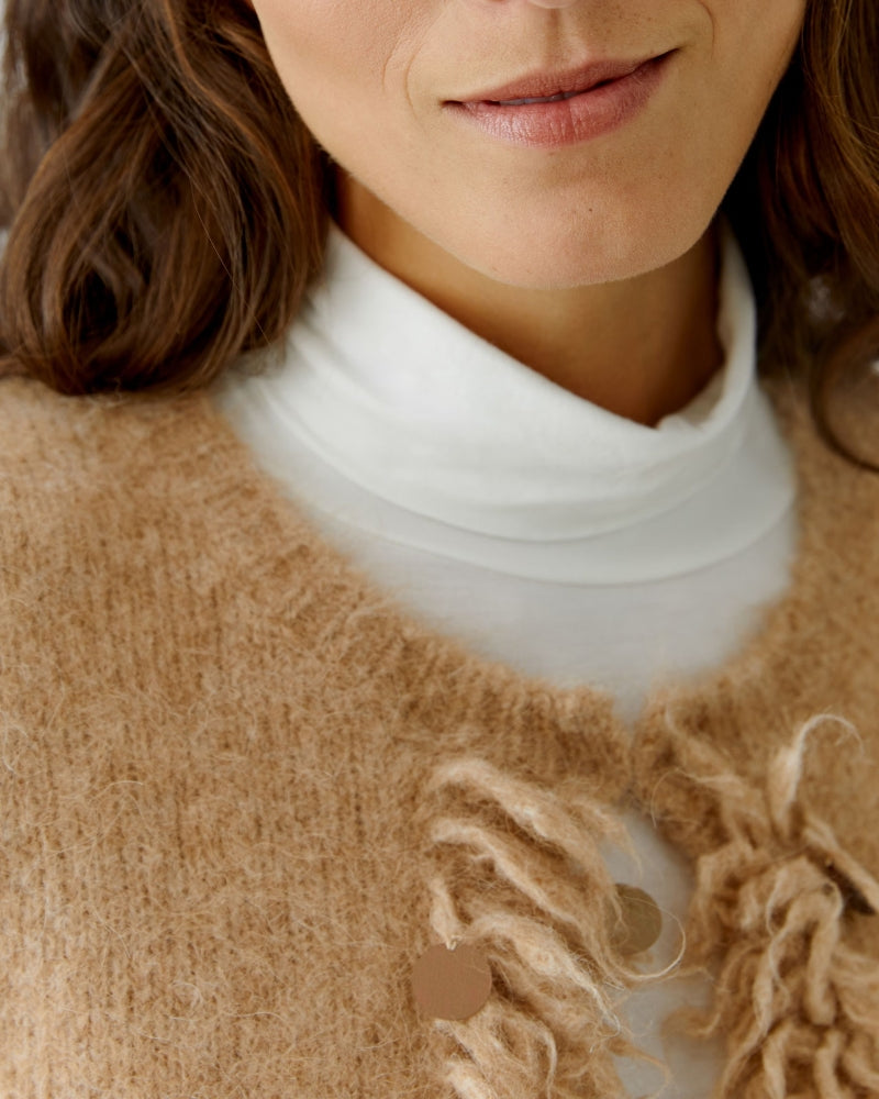 Close-up of sequin detail along front edge of Oui knit jacket in beige