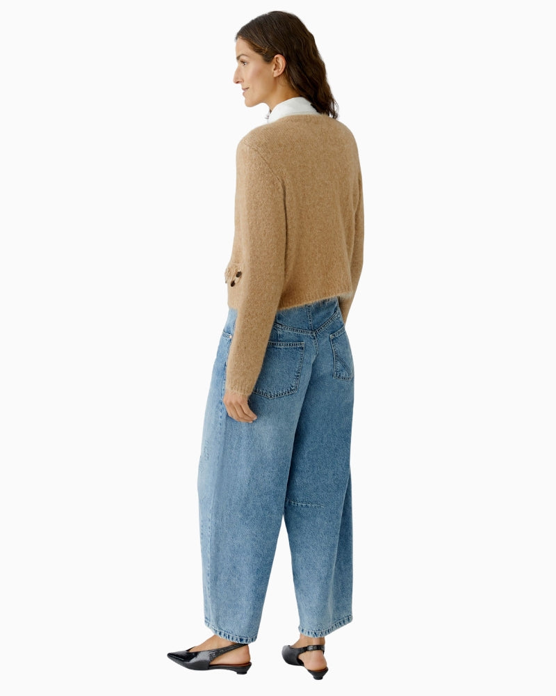 Back view of beige knit jacket showing casual cropped fit