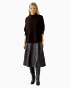 Model showcasing swinging midi length of dark brown A-line skirt by Oui