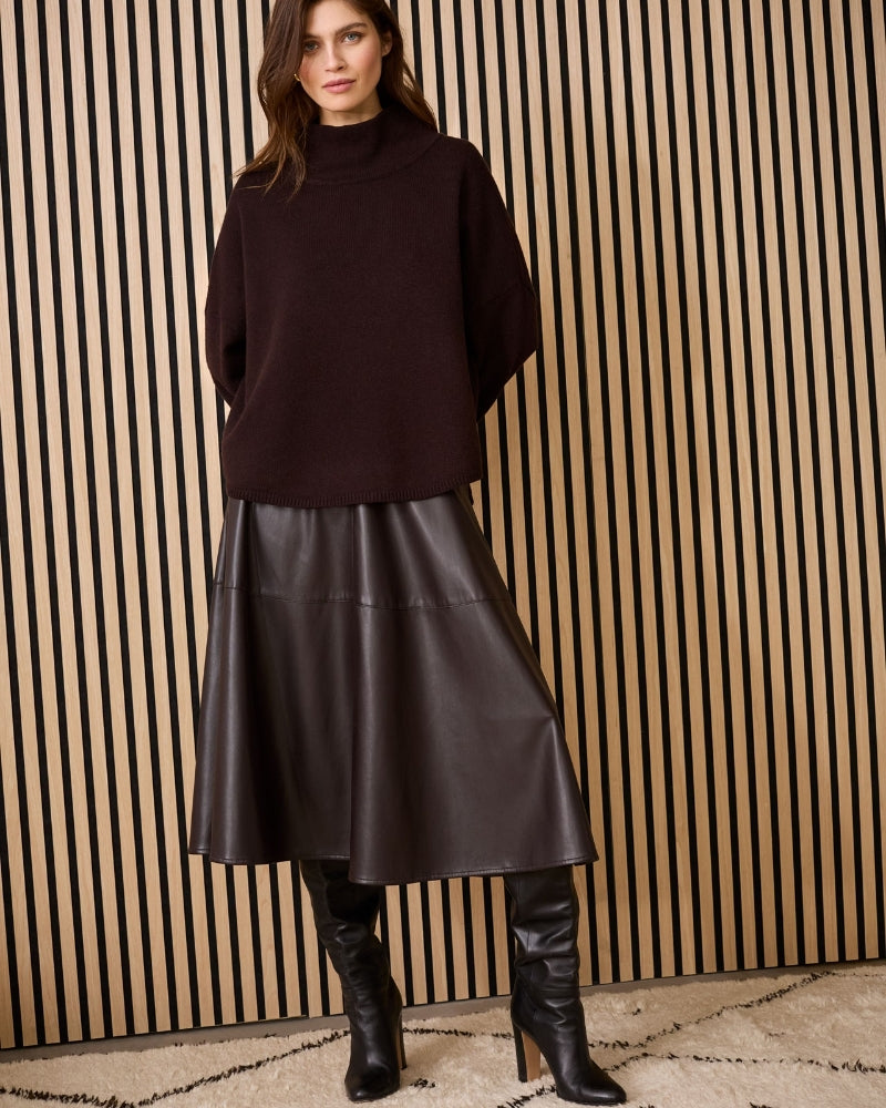 Model wearing dark brown Oui A-line faux leather midi skirt with brown sweater
