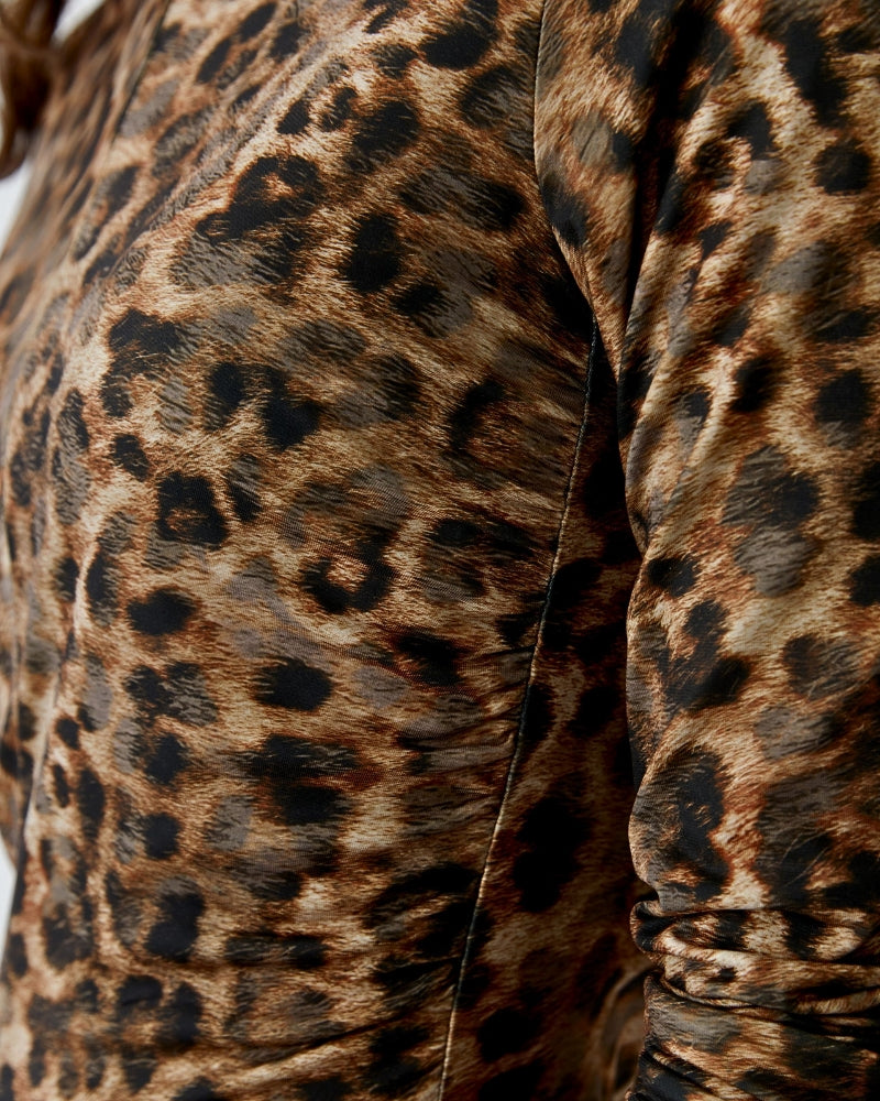 Detail of waist gathers for flattering fit on leopard print dress