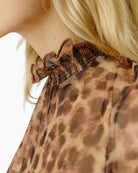 Close-up of smocked stand-up collar with ruffle edge on Oui leopard mesh shirt