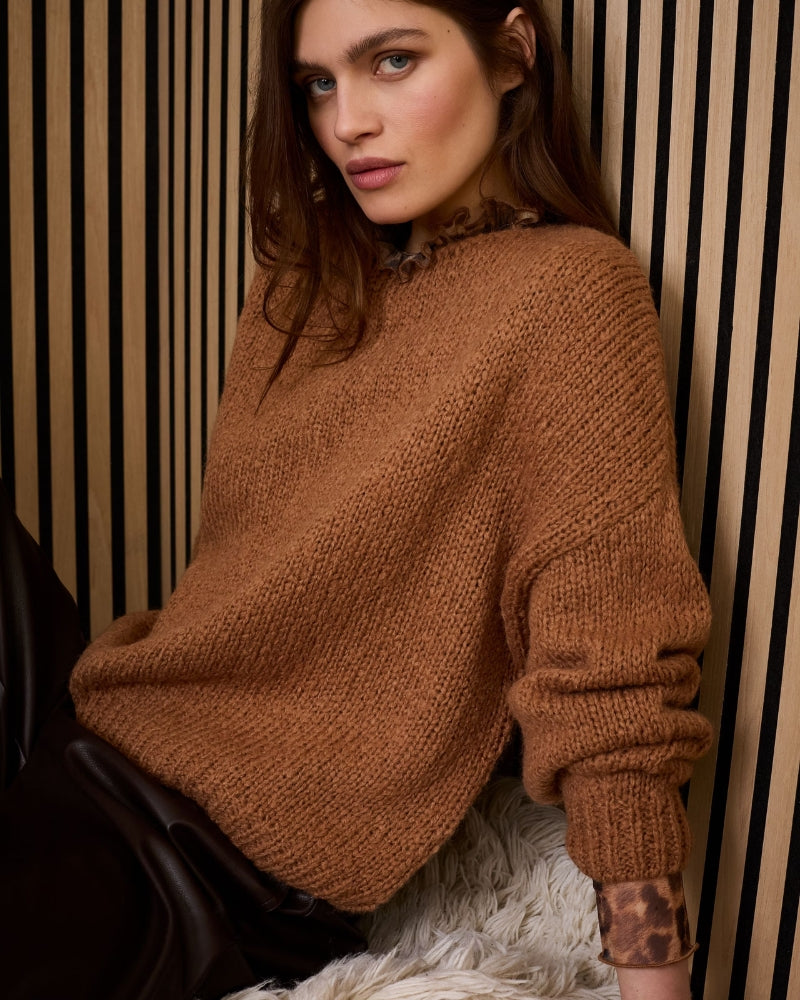 Model wearing Oui leopard mesh long-sleeve shirt with ruffle collar underneath sweater