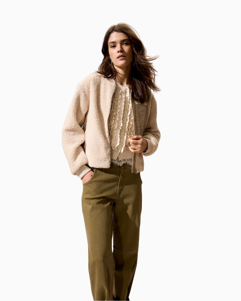 Model wearing cropped teddy jacket with nylon accents