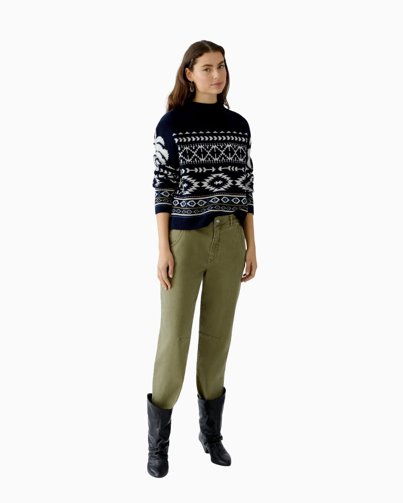 Model wearing Oui Nordic knit pullover styled with jeans and ankle boots for winter look