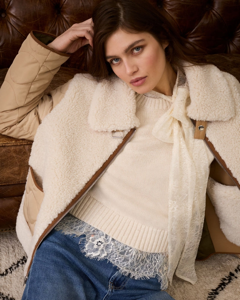 Model wearing Oui Reversible Outdoor Jacket paired with jeans