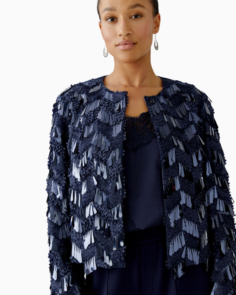 Close-up of mixed matte and shiny sequins on mesh fabric