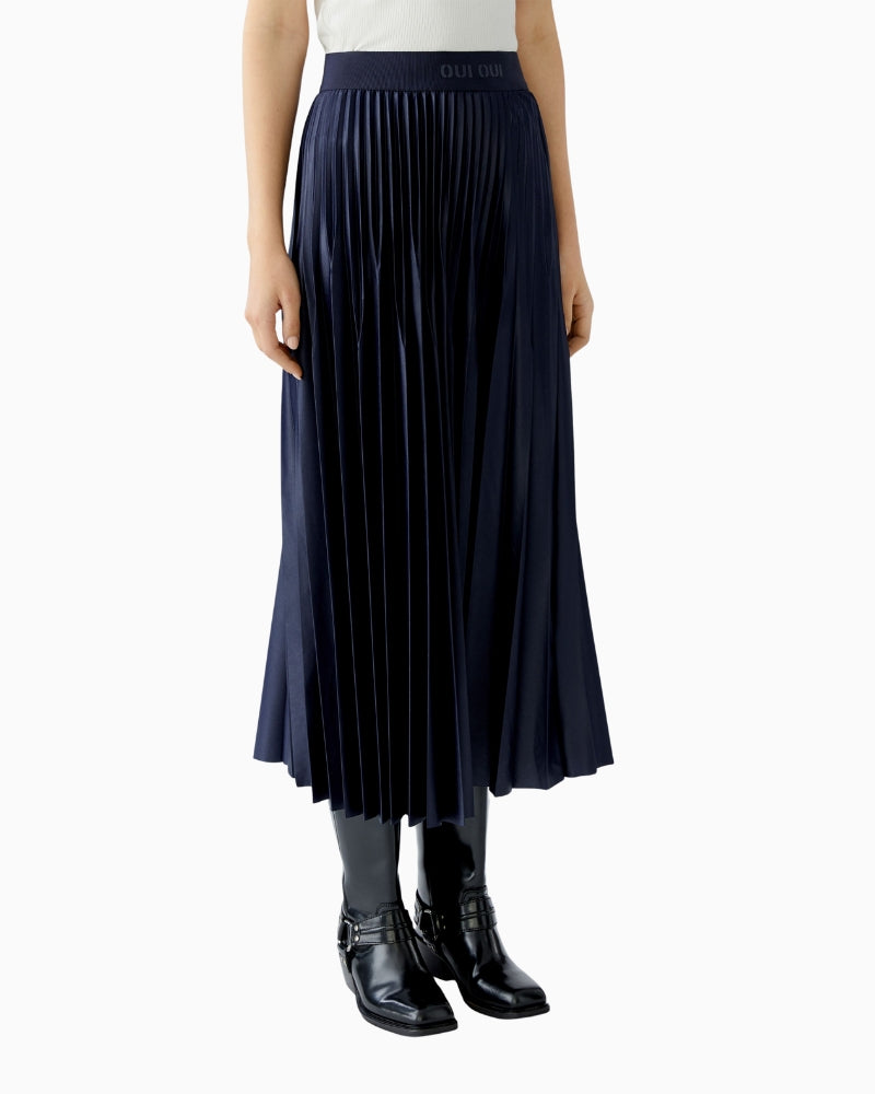 Side angle showing movement and drape of coated pleats