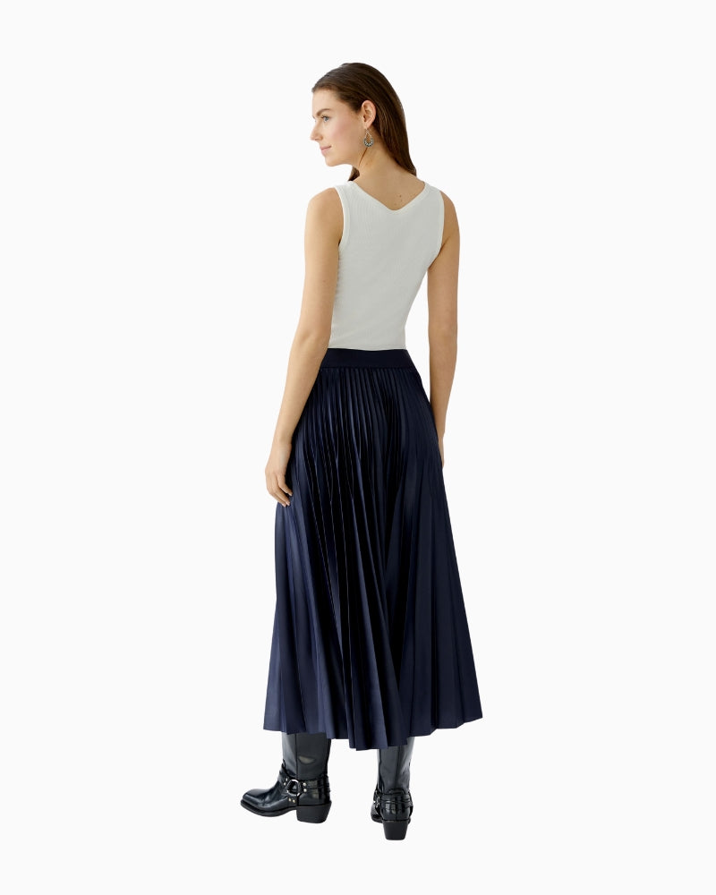Back view of pleated maxi skirt with flowing silhouette