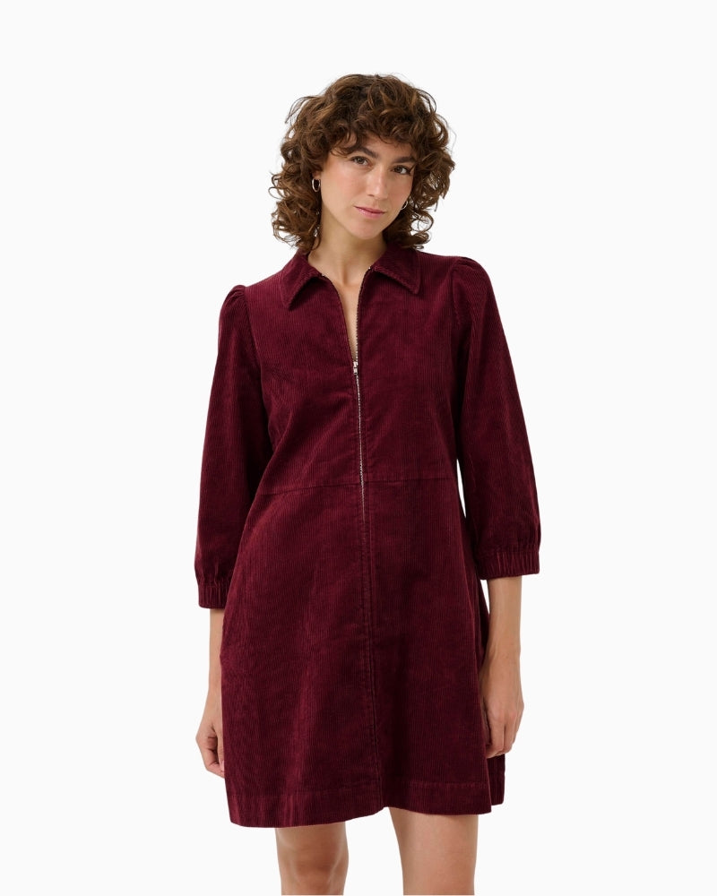 Front view of burgundy corduroy dress by Part Two with zip closure and classic collar