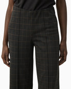 Close-up of soft check fabric and waistband detail on Part Two trousers