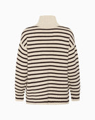 Back view of roll-neck knit with dropped shoulders and side slits