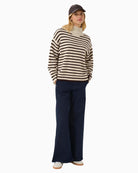 Model wearing relaxed fit roll-neck styled with jeans for everyday wear