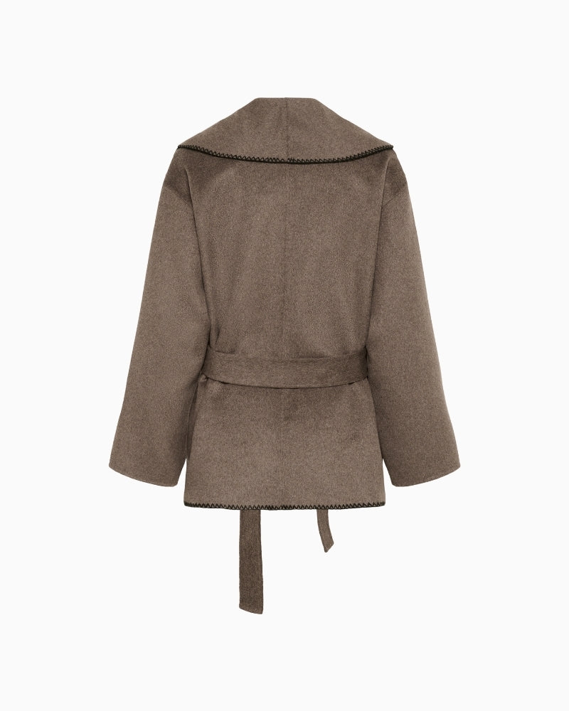 Back view of mid‑hip jacket with tailored silhouette and elegant finish