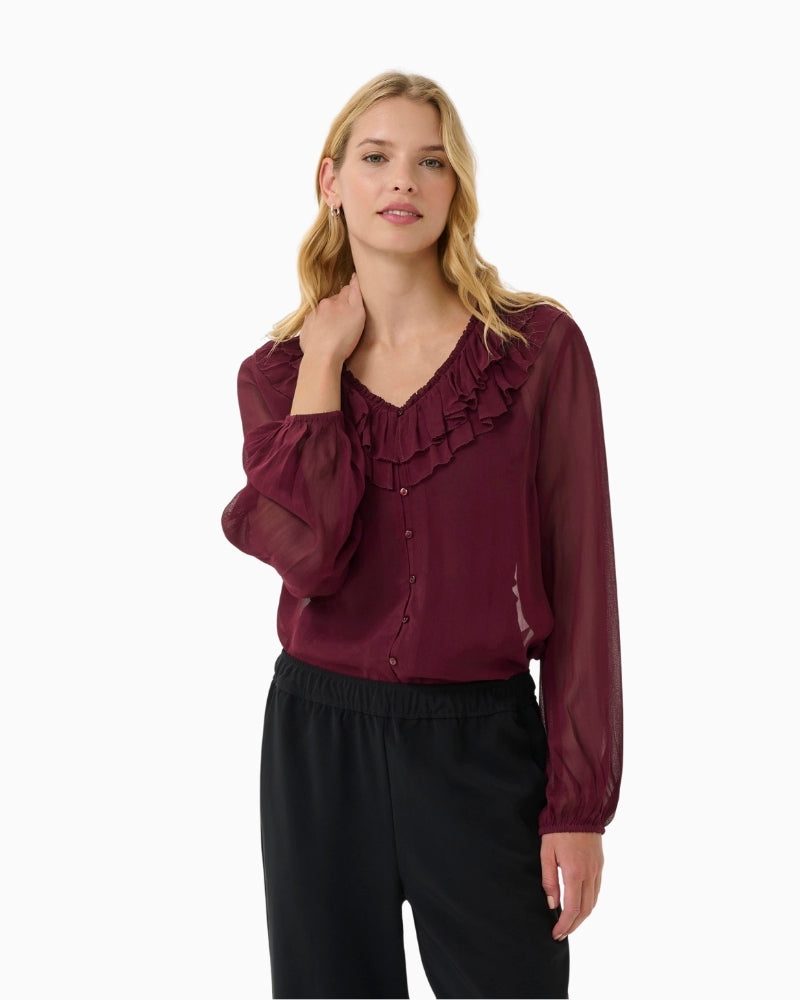 Front view of burgundy sheer blouse by Part Two with ruffled neckline and button front