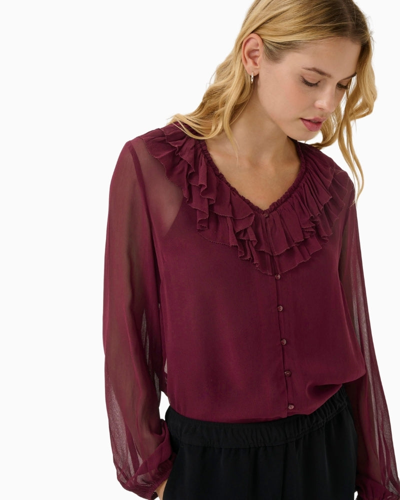 Close-up of ruffle detailing and lightweight viscose fabric on Sanaz blouse