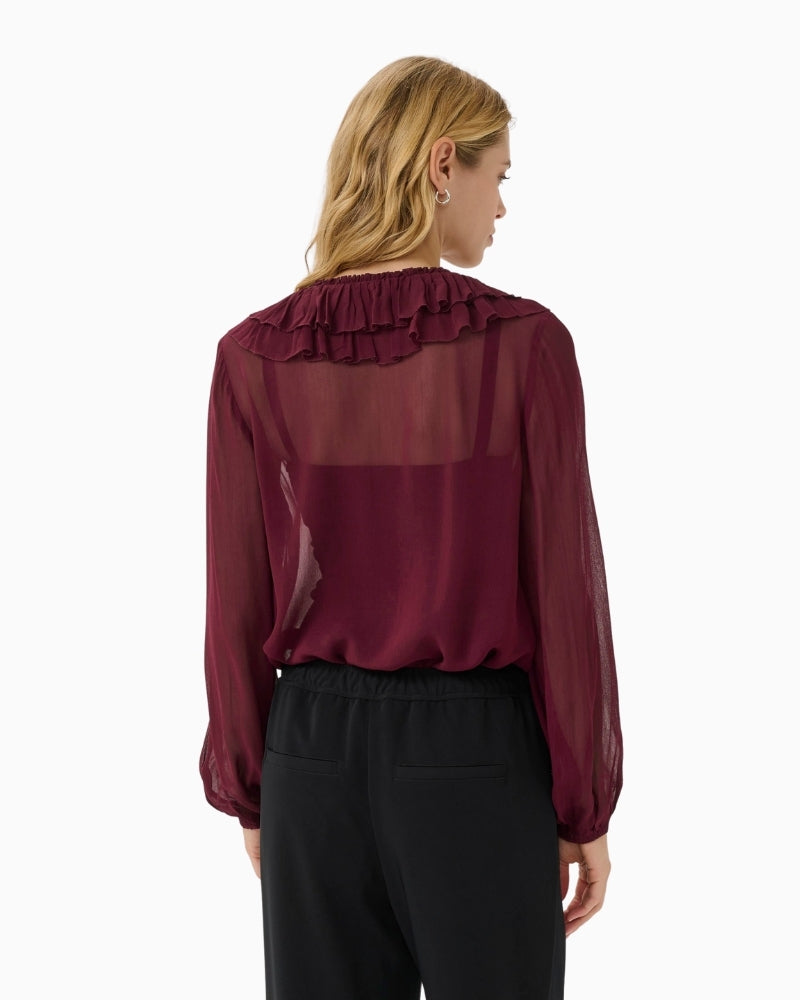 Back view of long-sleeve sheer burgundy blouse with soft drape