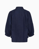 Back view of cotton denim blouse with soft structure and cropped sleeves