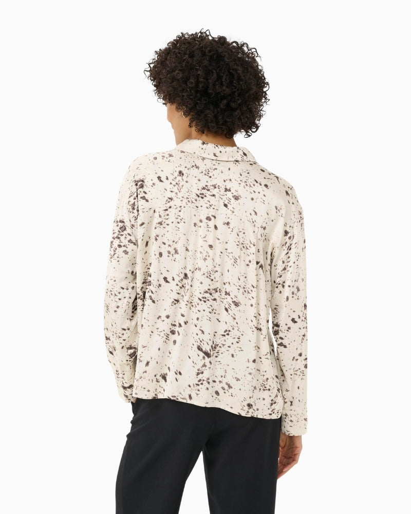 Back view of relaxed fit blouse showing long sleeves and soft drape