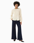 Front view of cream blouse with relaxed fit