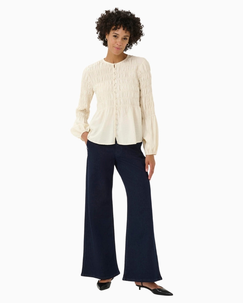 Front view of cream blouse with relaxed fit